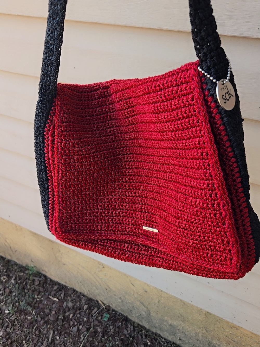 The Sak Red Crochet Shoulder Bag with Black Trim and Tag